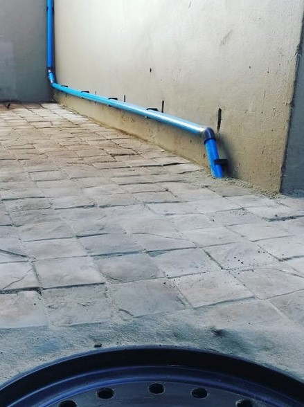 Storm water collection tank installation with drainage pump